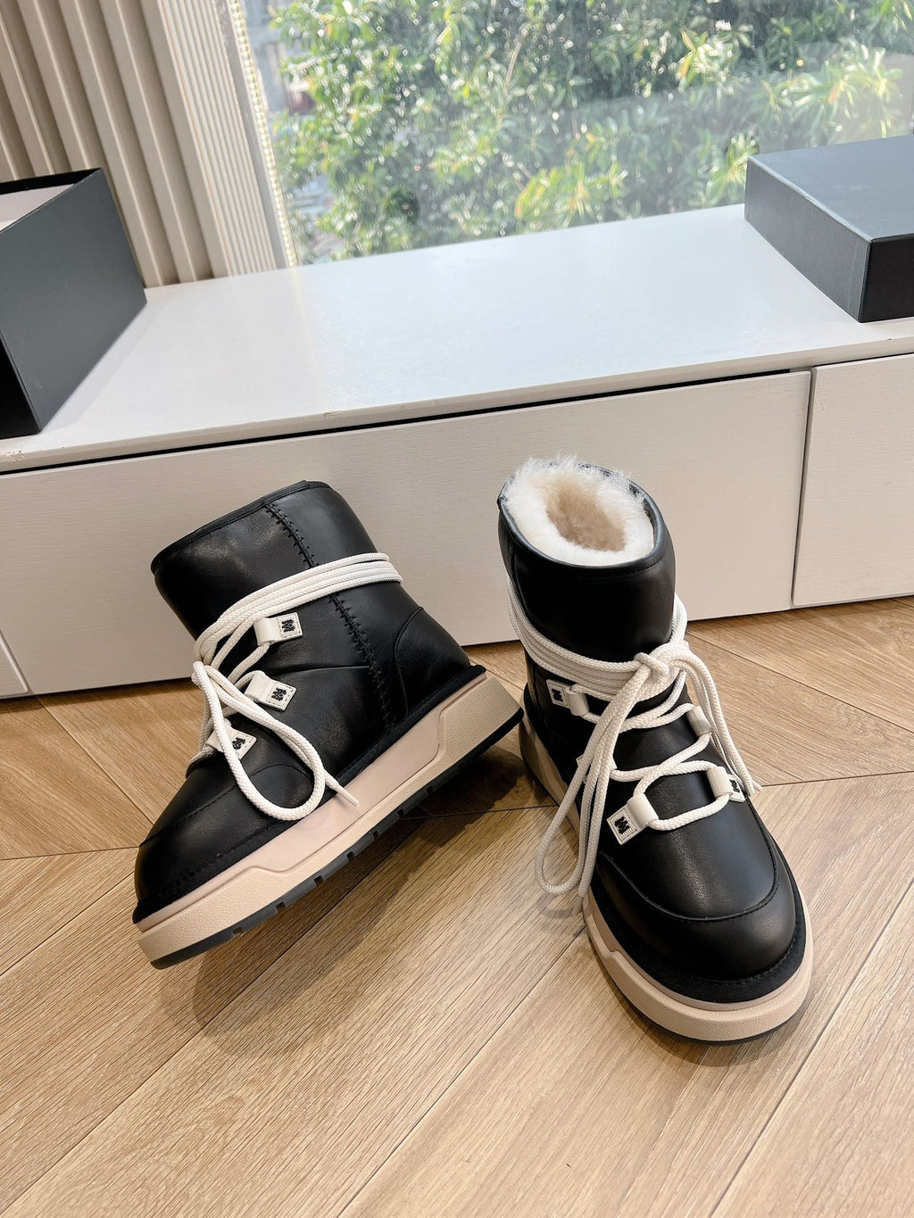 Amiri black high-top sneakers with cream lace-up, beige midsole, side view