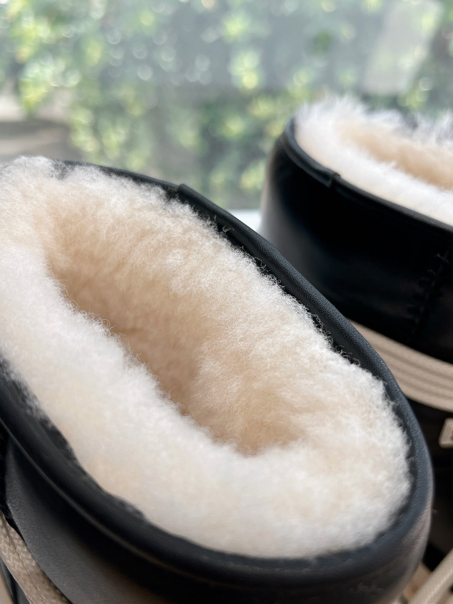 Amiri black high-top sneaker cuff with cream shearling lining detail