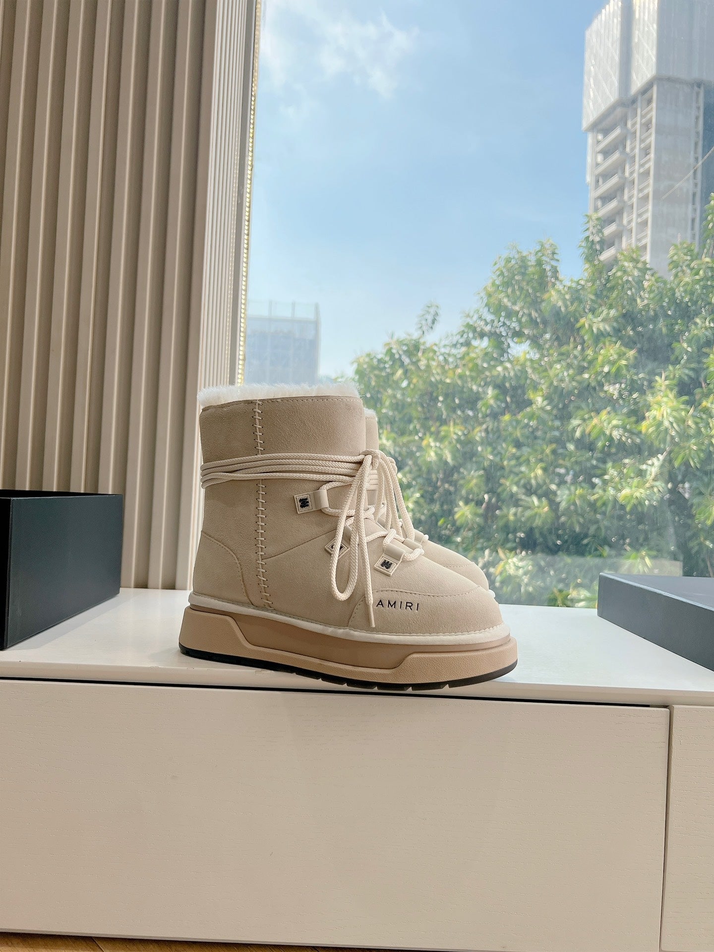 Beige lace-up high-top boot with faux fur collar and stitched side panel