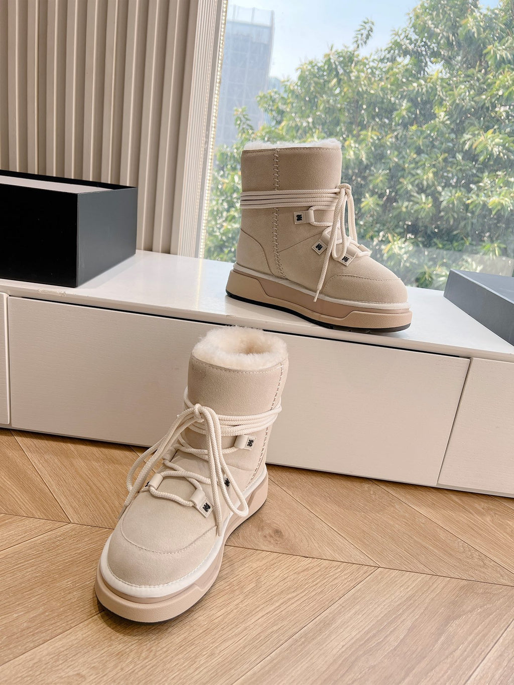 Pair of beige lace-up winter boots with fur-lined cuffs and thick sole