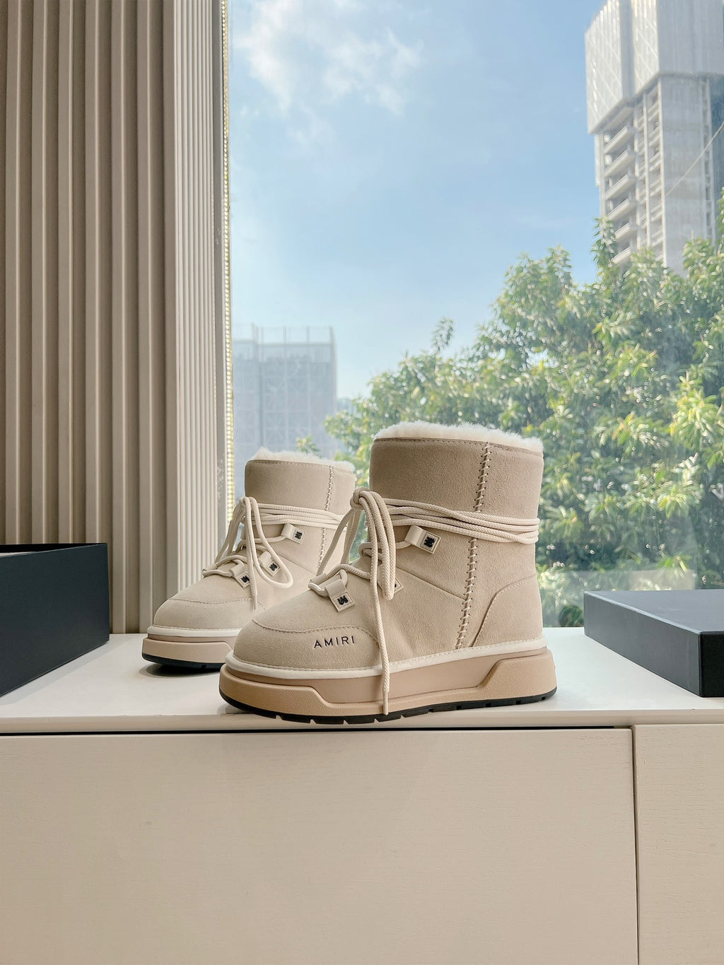 Beige suede lace-up high-top boots with faux fur trim and tan sole