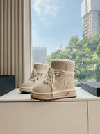 Beige suede lace-up high-top boots with faux fur trim and tan sole