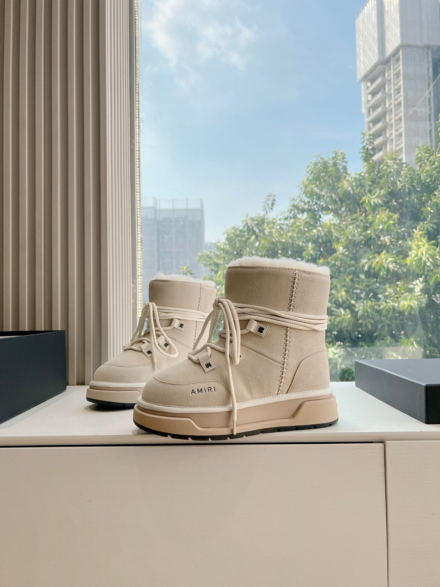 Beige suede lace-up high-top boots with faux fur trim and tan sole