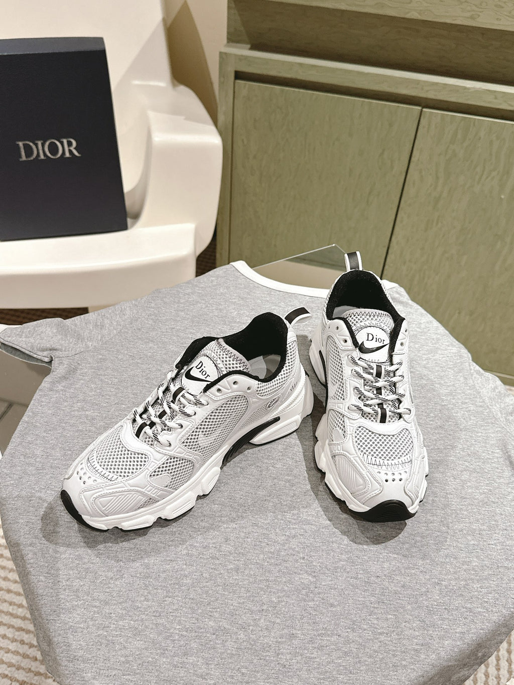 White lace-up sneakers with Dior logo tongue, black heel trim, chunky platform sole
