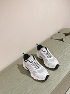 White lace-up sneakers with Dior logo, black heel tab, padded collar