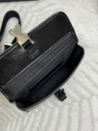 Prada bag black with jacquard logo panel, silver clasp, and top strap hardware