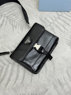 Prada bag in black with flap top, silver clasp, and adjustable strap