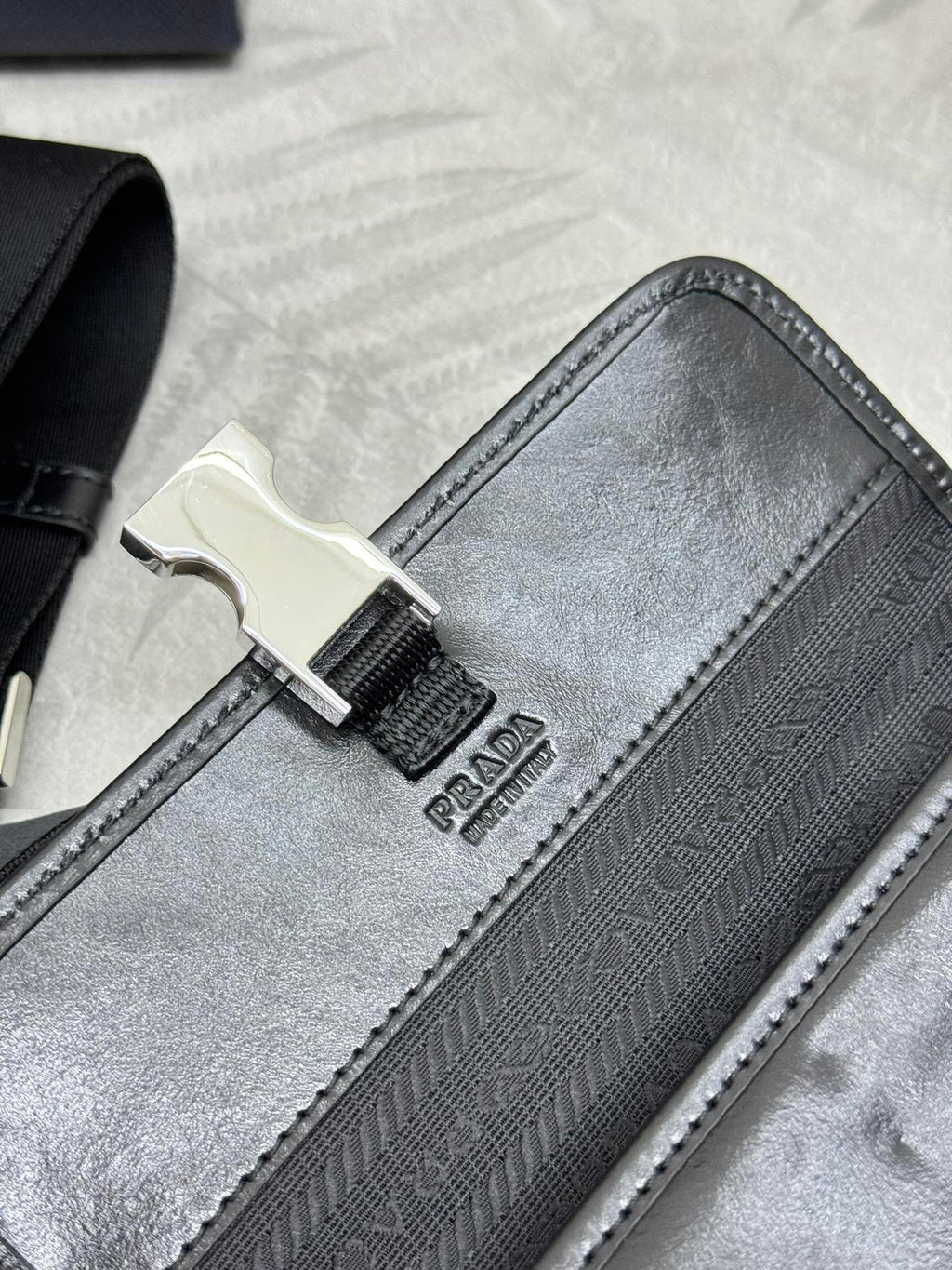 Prada bag black with jacquard pattern and metal buckle on the strap