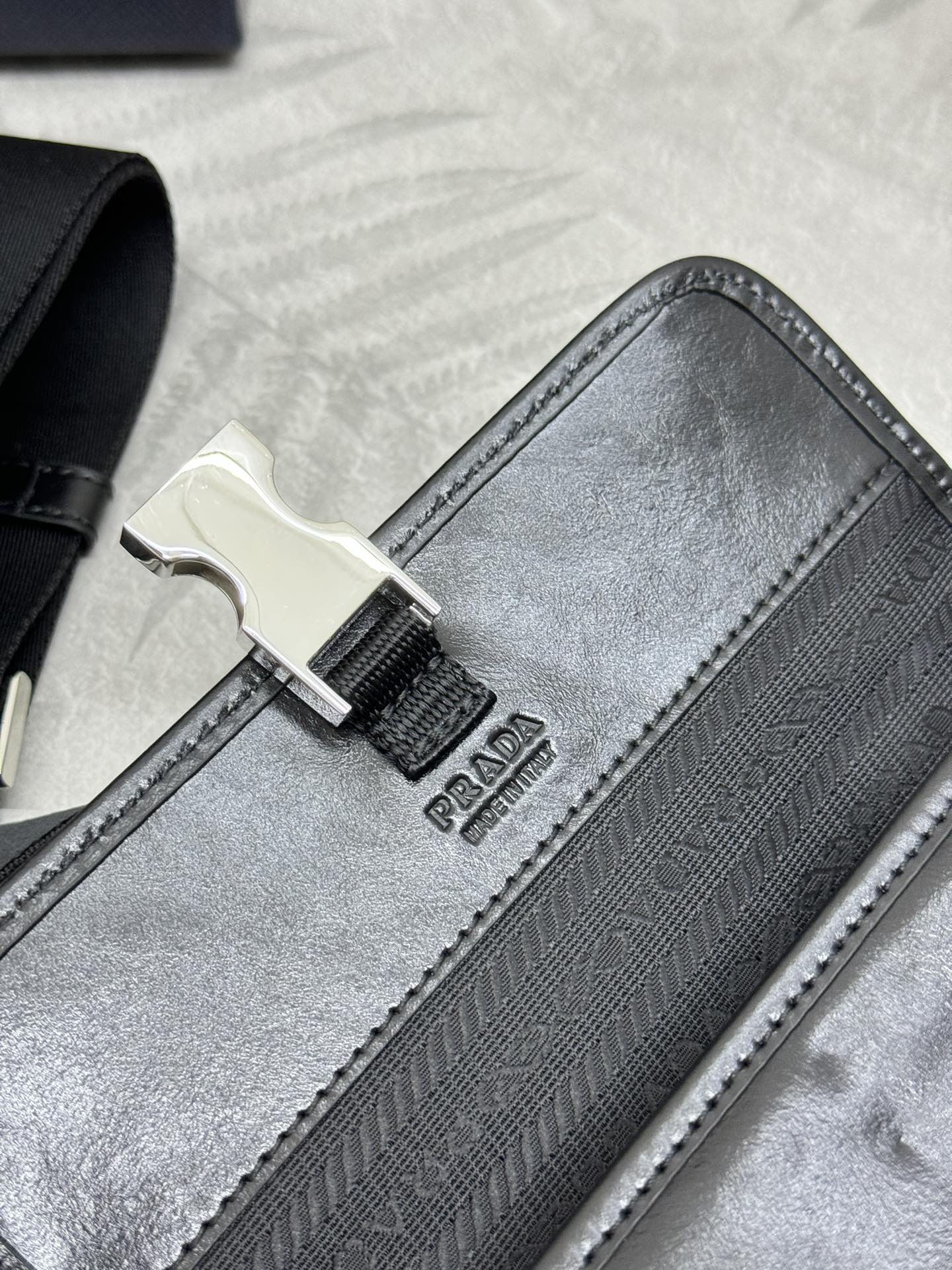 Prada bag black with jacquard pattern and metal buckle on the strap