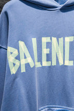Light blue hoodie chest graphic with stylized “BALENCI…” lettering in pale blue and white