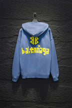 Light blue hoodie with hood, back yellow graphic text, and bright symbol logo on the back