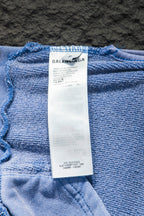 Light blue hoodie inside label at hem with printed size and care information