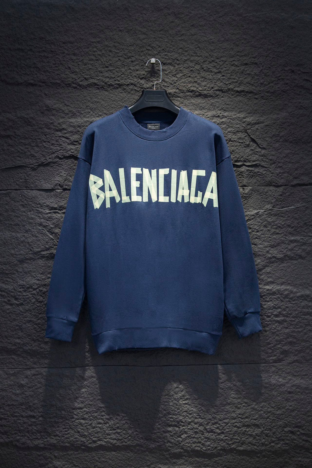 Blue sweatshirt with white Balenciaga-style graphic logo