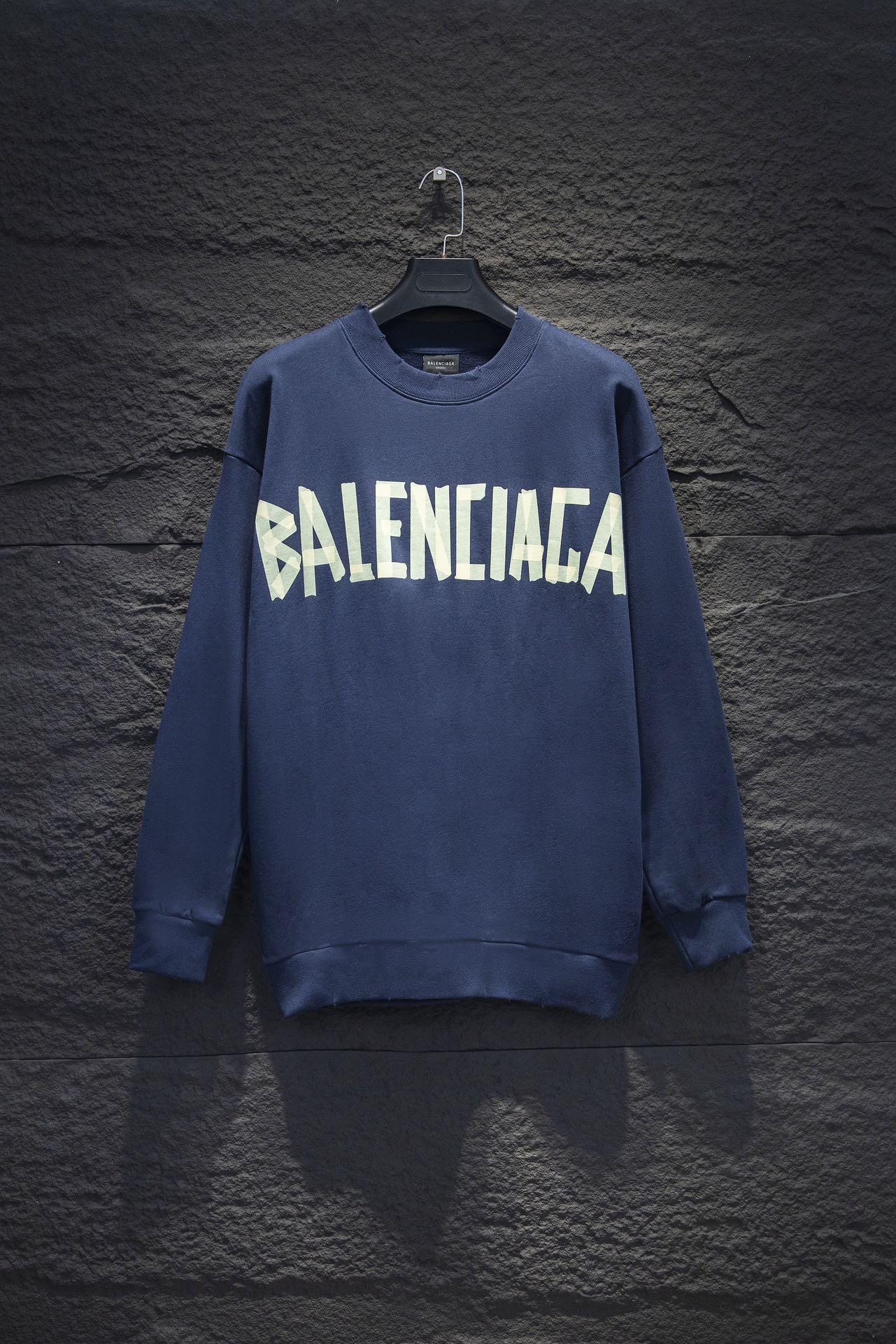 Blue sweatshirt with white Balenciaga-style graphic logo