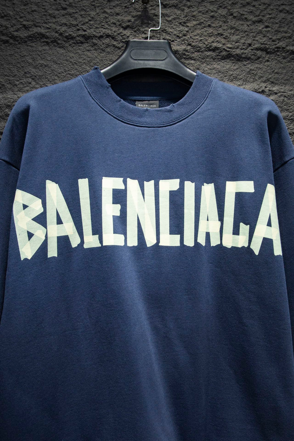 Blue sweatshirt with large white Balenciaga logo across chest