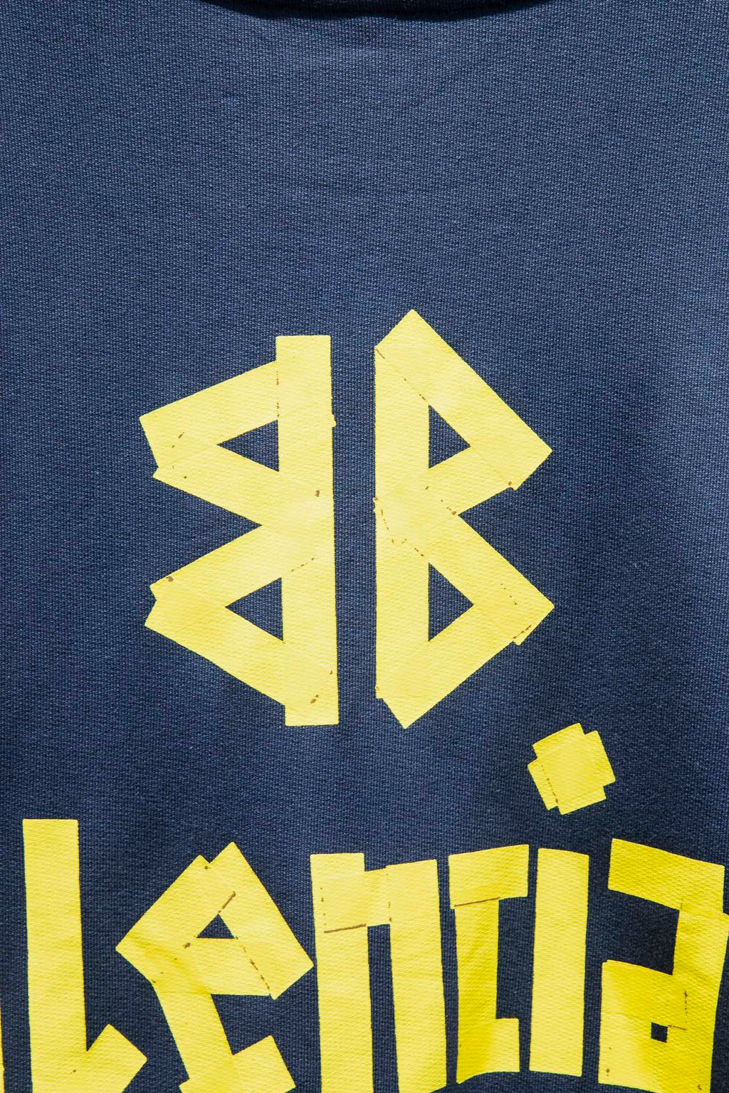 Blue sweatshirt with close-up yellow graphic letters and logo