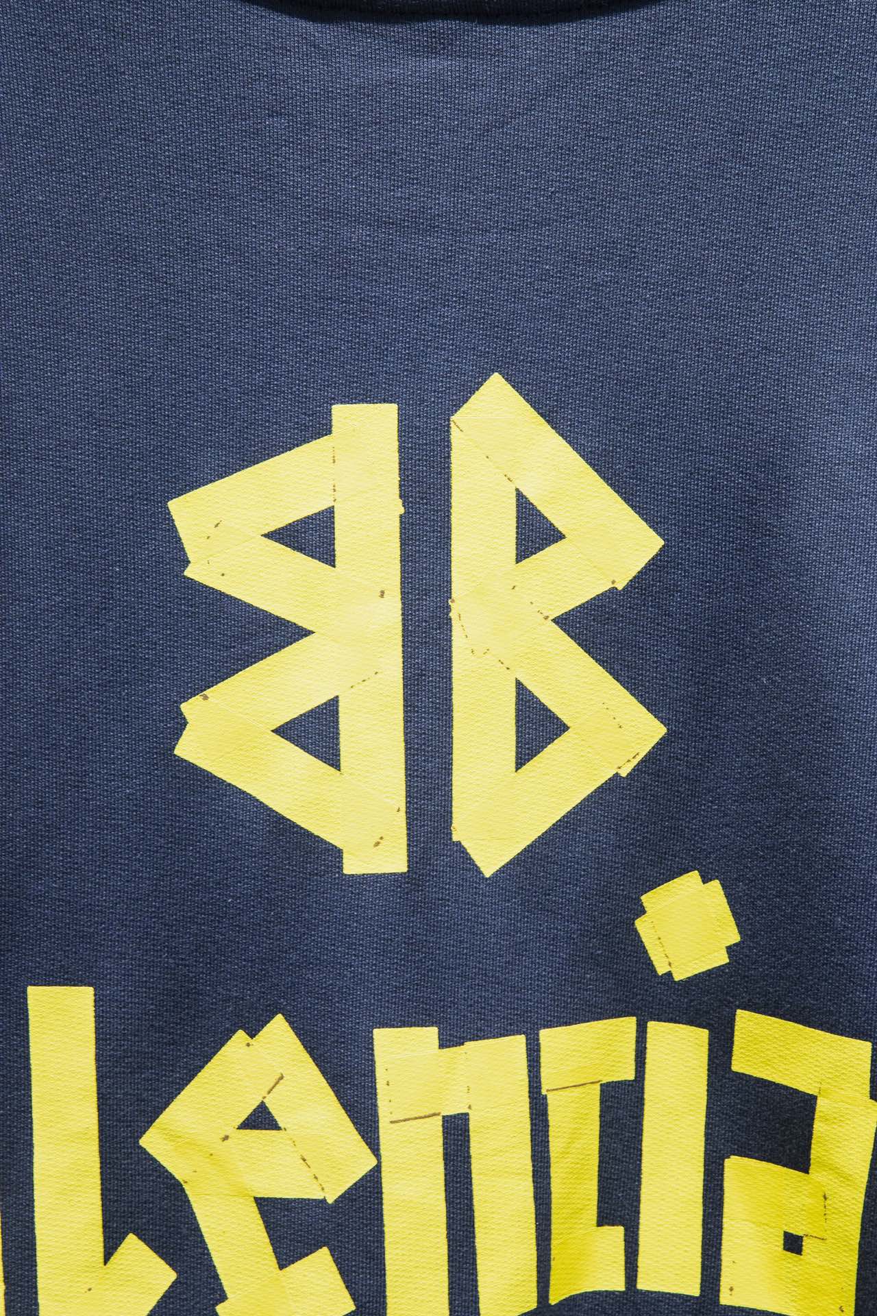 Blue sweatshirt with close-up yellow graphic letters and logo
