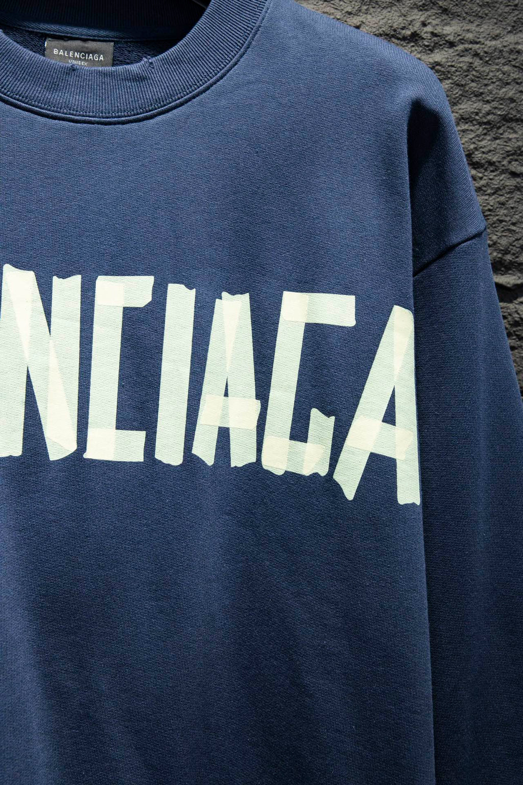 Blue sweatshirt with partial white Balenciaga logo lettering
