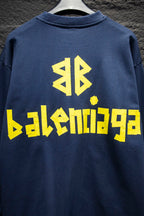 Blue sweatshirt with large yellow Balenciaga-style logo on back
