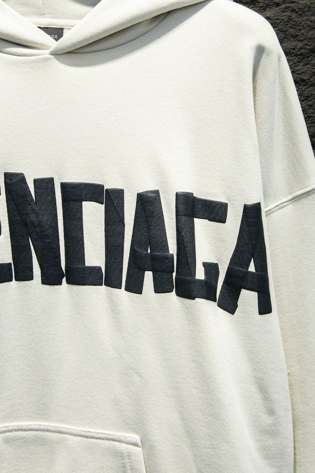 White hoodie with oversized black Balenciaga logo lettering across chest