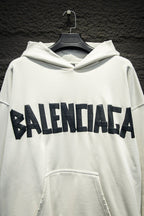 White Balenciaga hoodie with front logo lettering and front kangaroo pocket