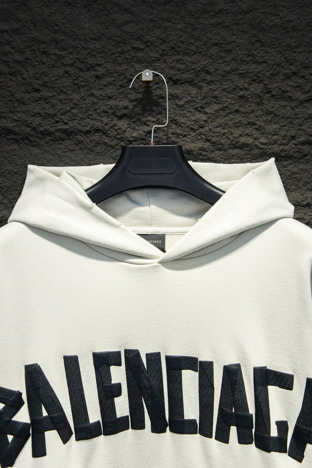 White hoodie hood and drawstring with large Balenciaga logo across chest