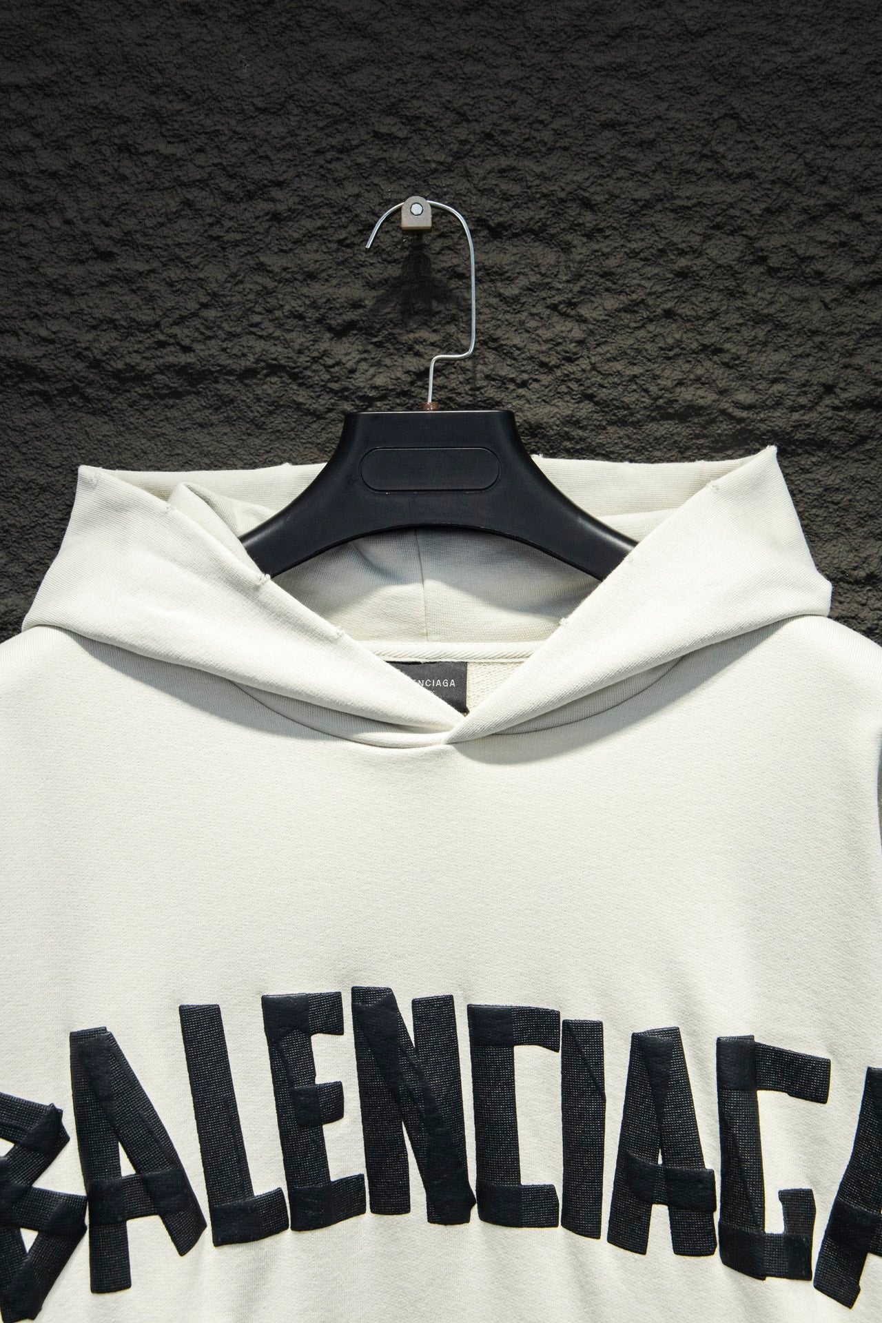 White hoodie hood and drawstring with large Balenciaga logo across chest