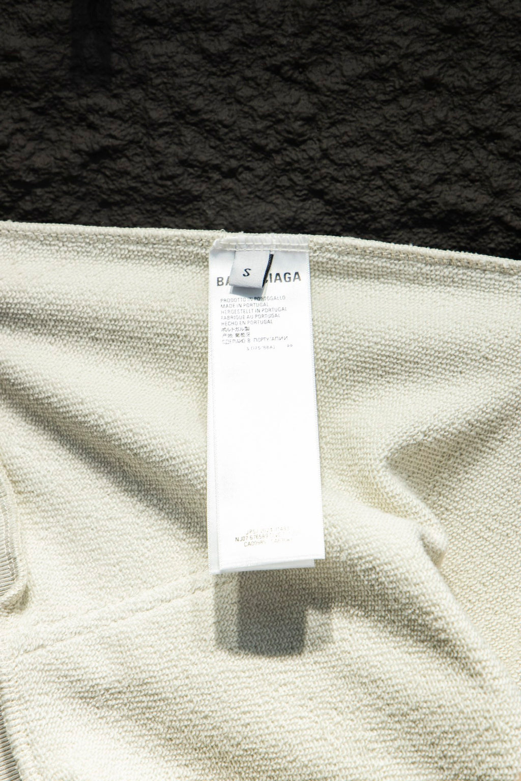 White hoodie label tag on fabric with Balenciaga branding