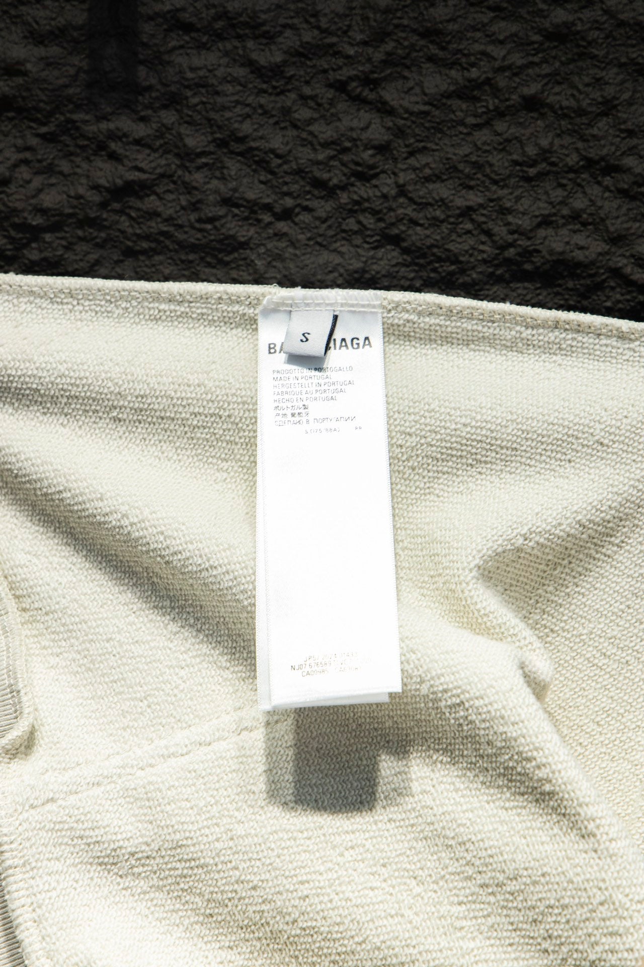 White hoodie label tag on fabric with Balenciaga branding