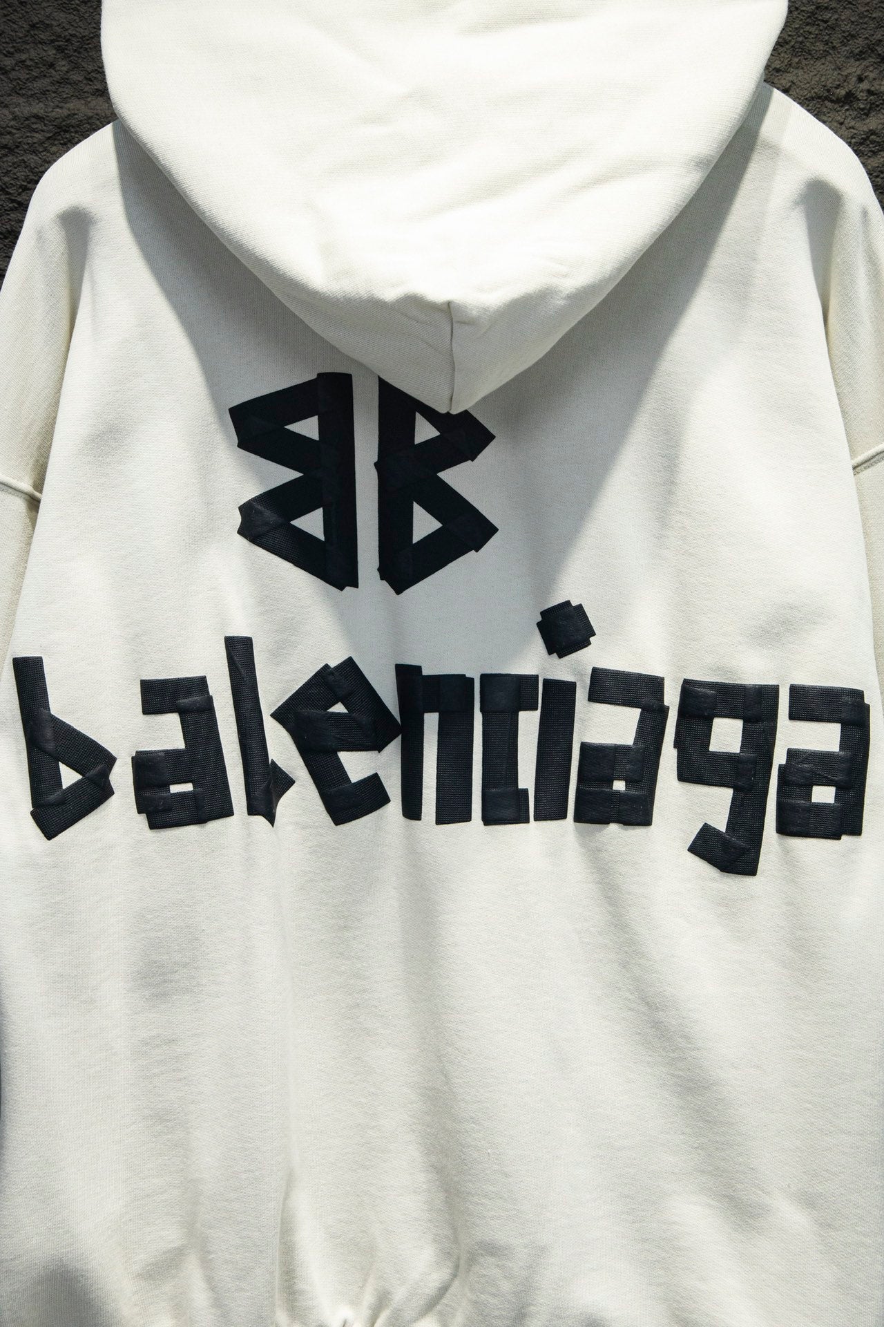 White hoodie back with large Balenciaga logo and hood seam detail