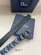 Dior belt flat view: navy strap with holes and blue monogram under gold buckle.