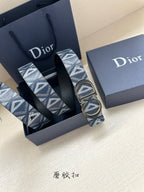 Dior belt in blue monogram with large gold-tone double D buckle, laid in box.