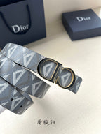 Designer belt detail: light gray monogram strap with oval and rectangular gold-tone buckle