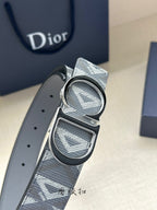Designer belt buckle close-up on gray monogram strap with round and oval panels