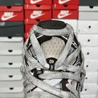 Gray sneaker tongue and heel with black logo patch and woven collar detail