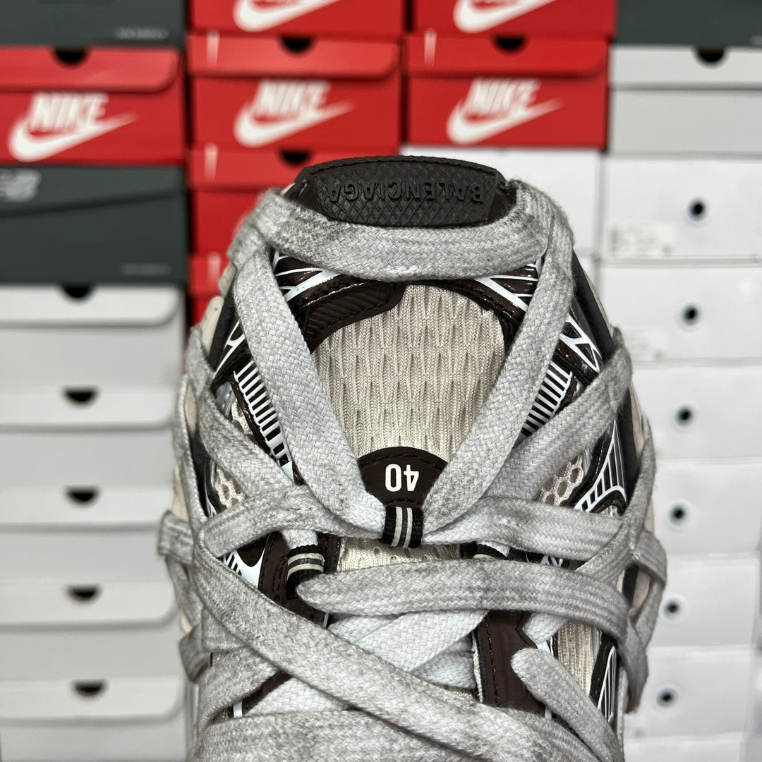 Gray sneaker tongue and heel with black logo patch and woven collar detail