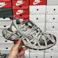 Gray Balenciaga-style unisex sneakers with crisscross laces and textured upper