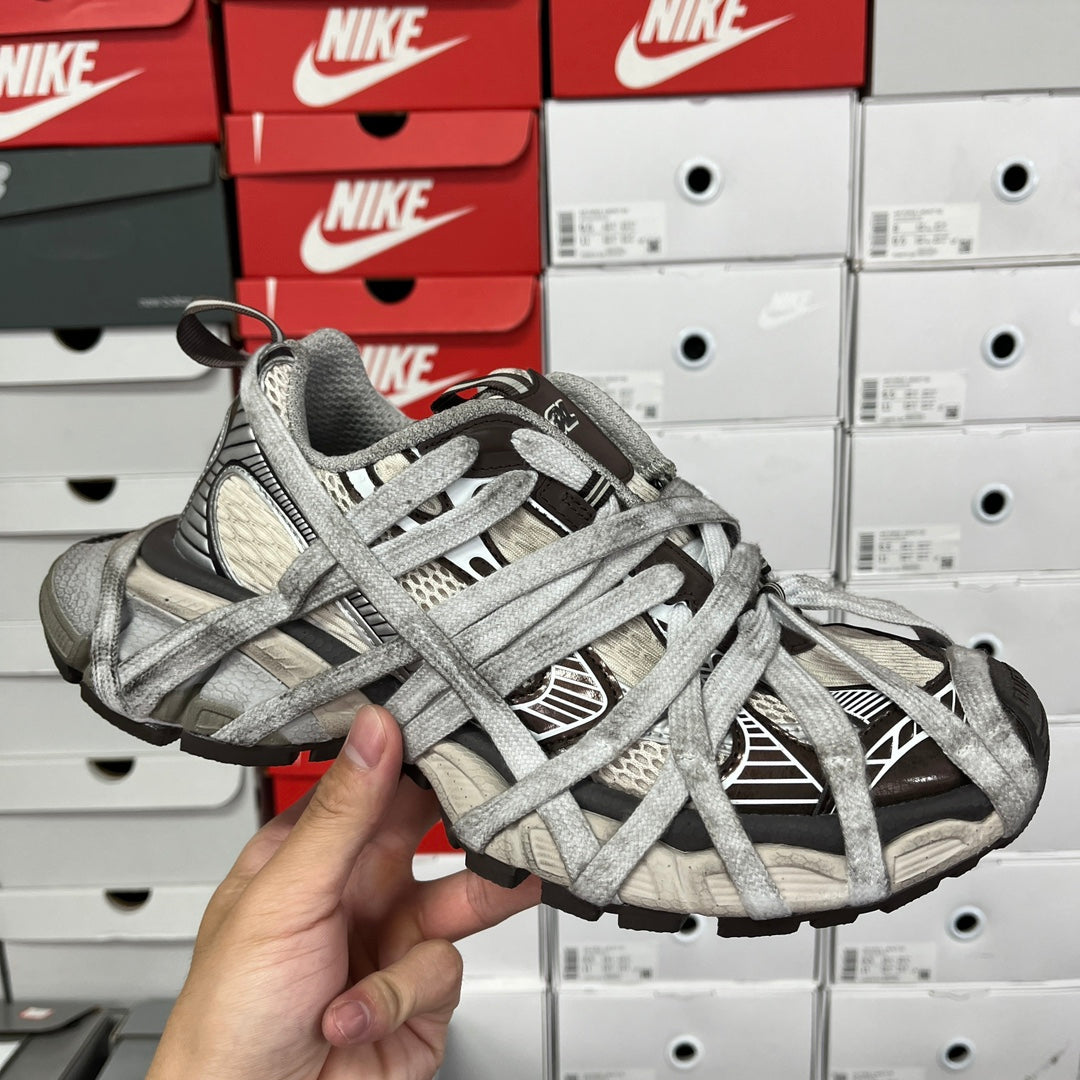 Gray Balenciaga-style unisex sneakers with crisscross laces and textured upper