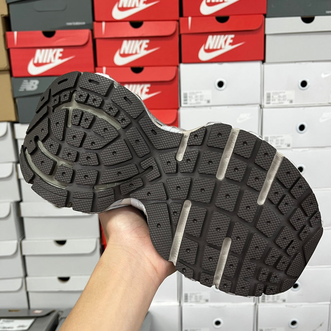 Gray sneaker outsole with deep tread and multiple rubber traction pods