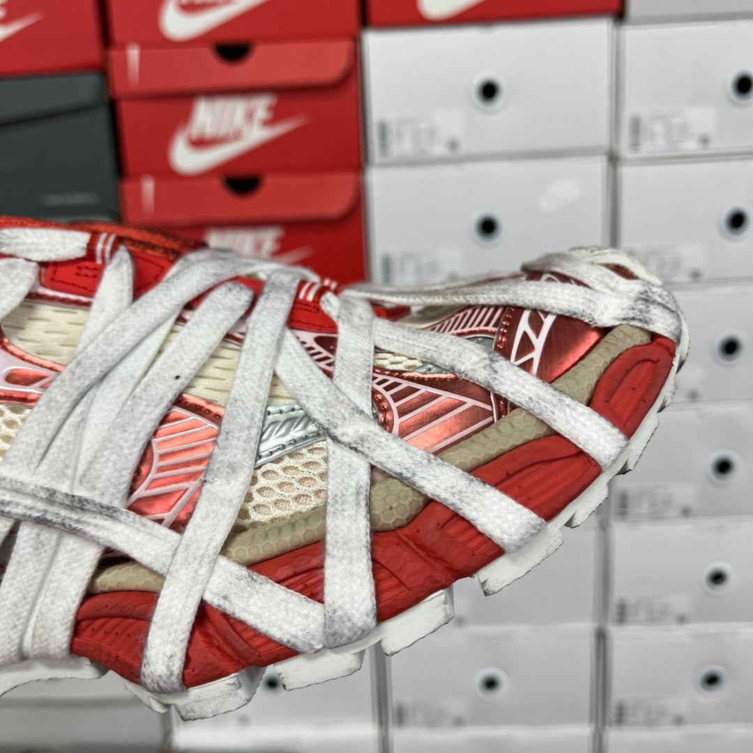 Unisex sneaker side view with red-and-beige panels and white lace-up straps