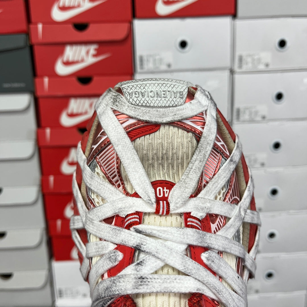 Unisex sneaker heel view with red trim, beige mesh upper, and white laces