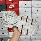Unisex sneaker outsole with textured white tread and red heel stripes