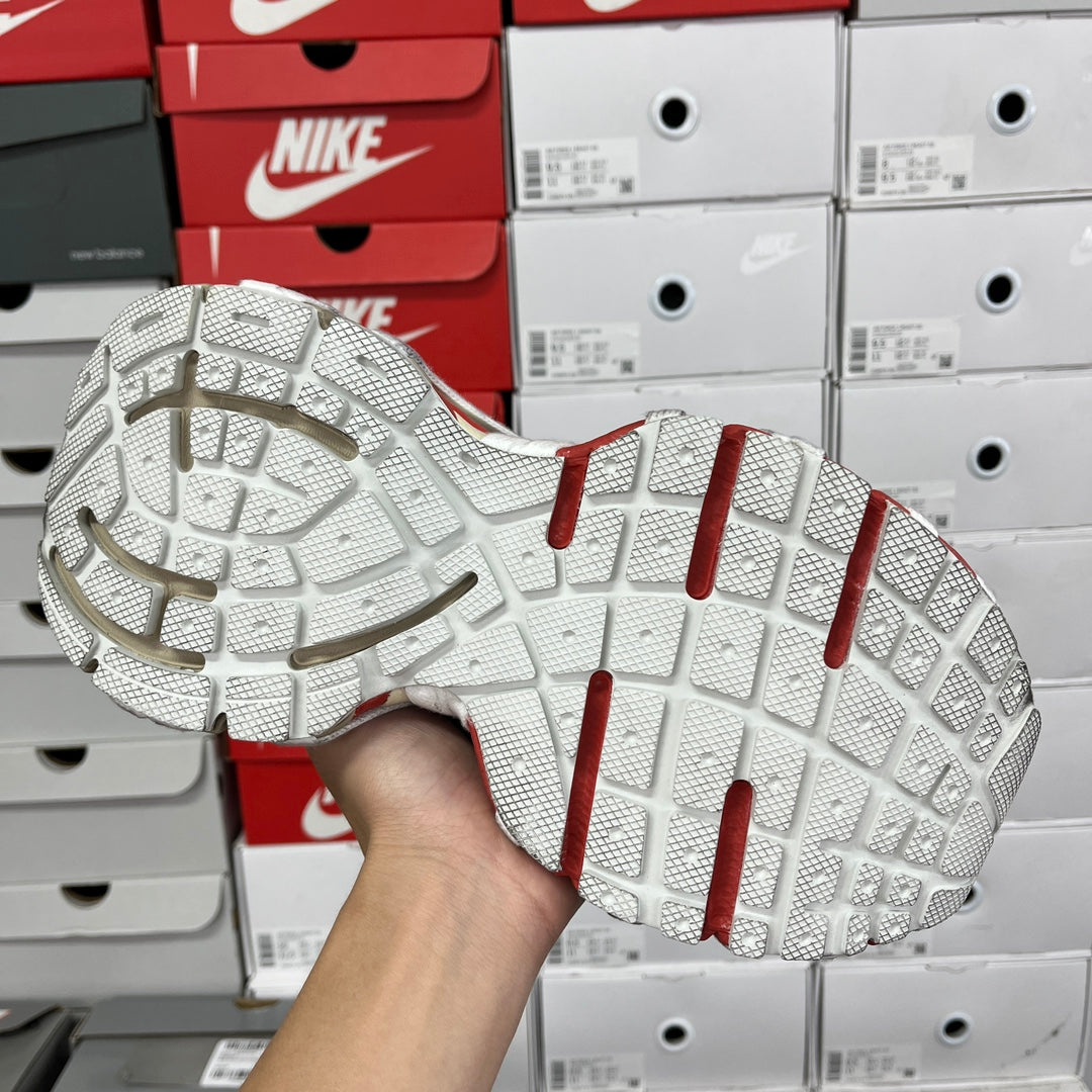Unisex sneaker outsole with textured white tread and red heel stripes