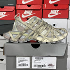 Lace-up sneaker, textured gray and olive upper with padded collar and chunky sole.