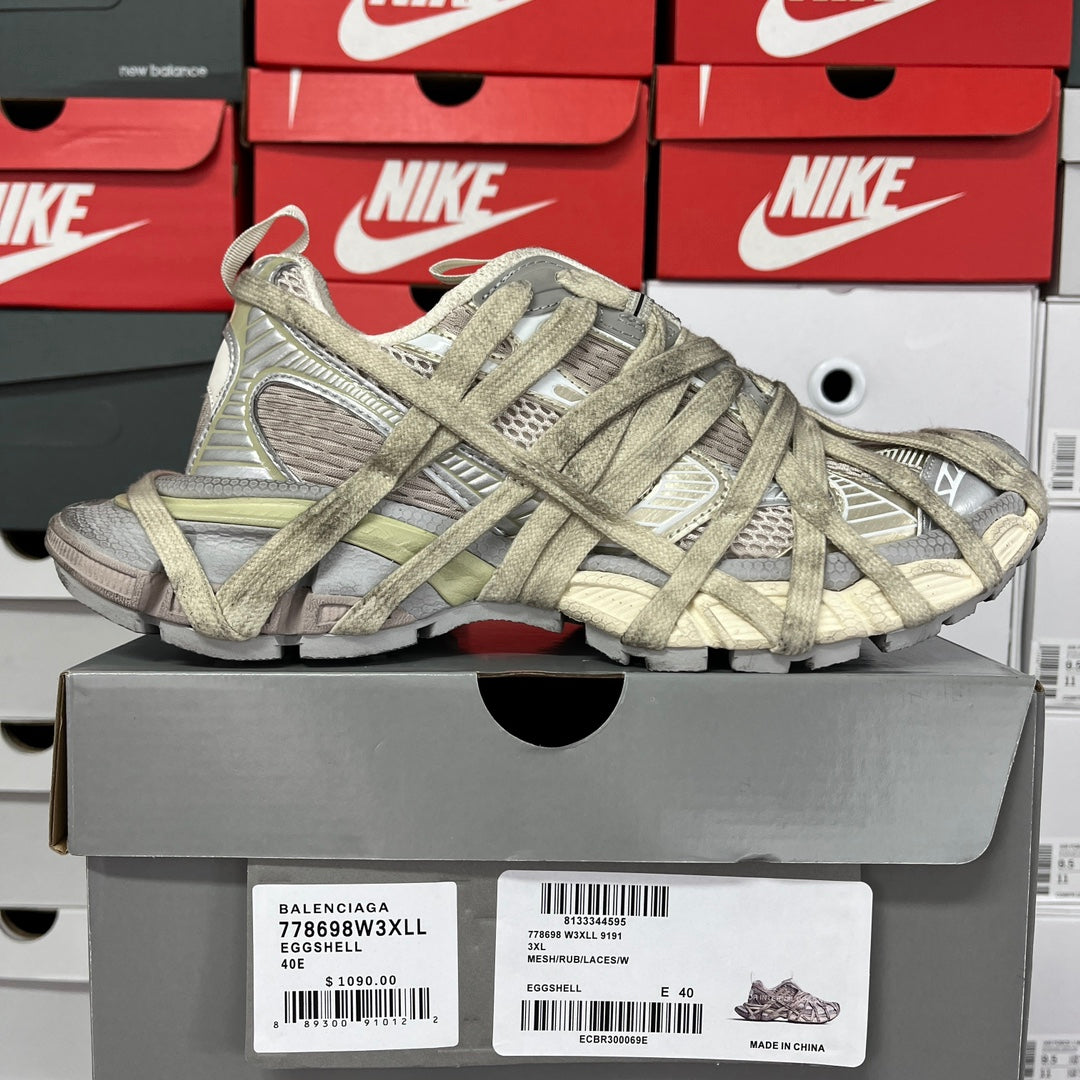 Lace-up sneaker, textured gray and olive upper with padded collar and chunky sole.
