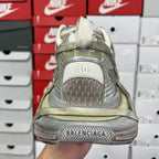 Rear of lace-up sneaker with '40' logo badge and textured gray and olive panels.