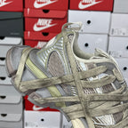 Lace-up sneaker with metallic gray and olive overlays and cushioned ankle collar.