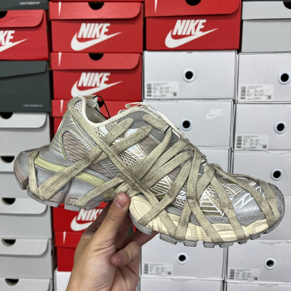 Lace-up sneaker with patterned gray and olive upper and chunky platform sole.