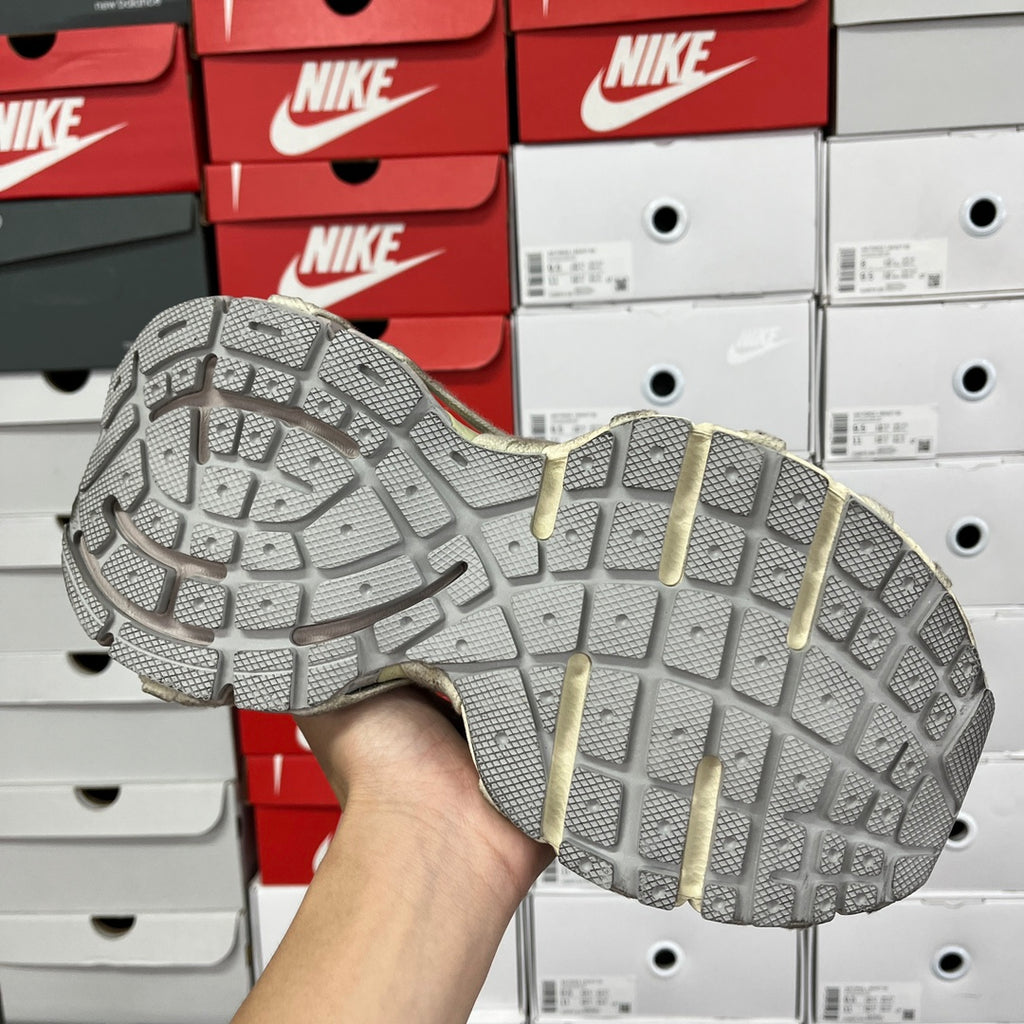 Shoe outsole with grid traction pattern and molded midsole details.