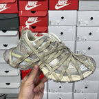 Lace-up sneaker with textured gray and olive uppers and chunky sole.